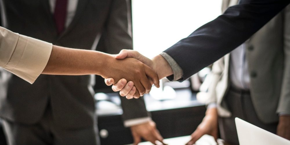 Business man and woman shaking hands