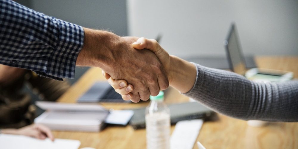 A man and woman shaking hands