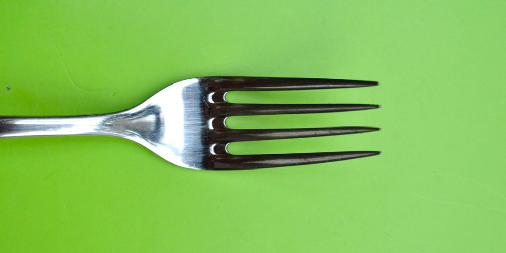 A fork on a green background