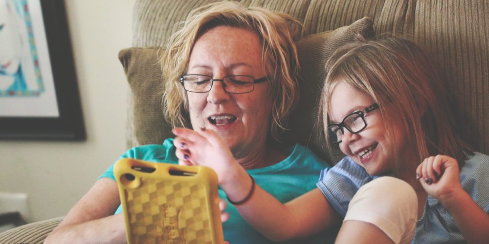 Gandmother and Granddaughter playing on a tablet