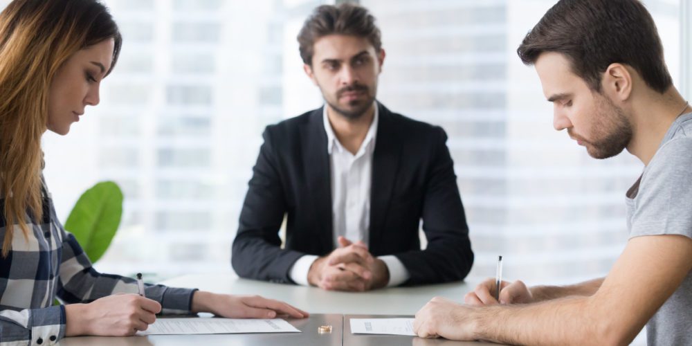 Two people meeting with a mediator